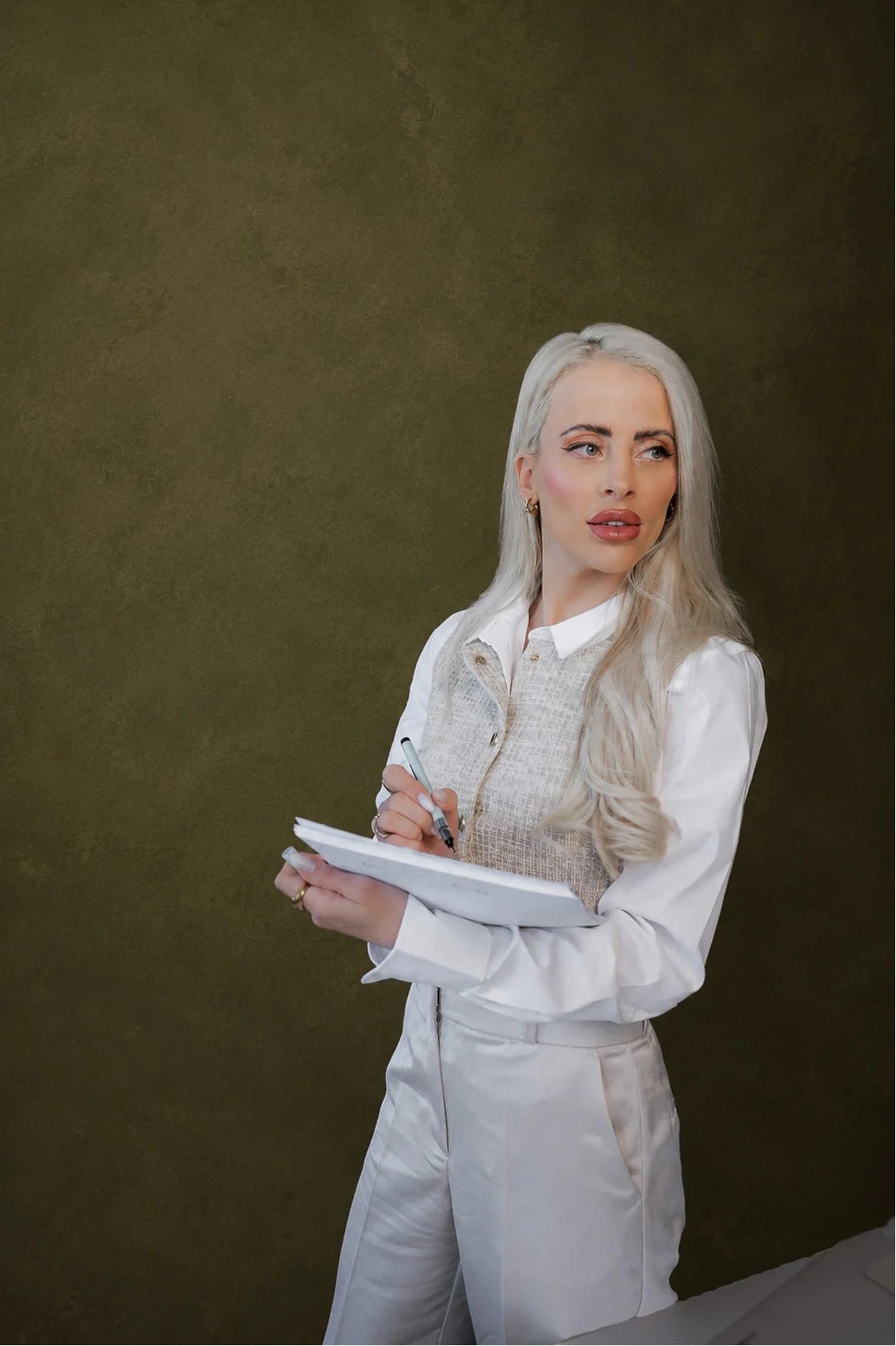 Bianca Da Silva, retail buying and product development consultant, holding a notebook and pen while reviewing sourcing notes